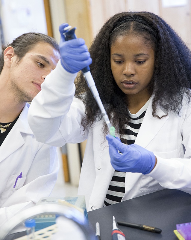 african american woman with pipette and white man looking on