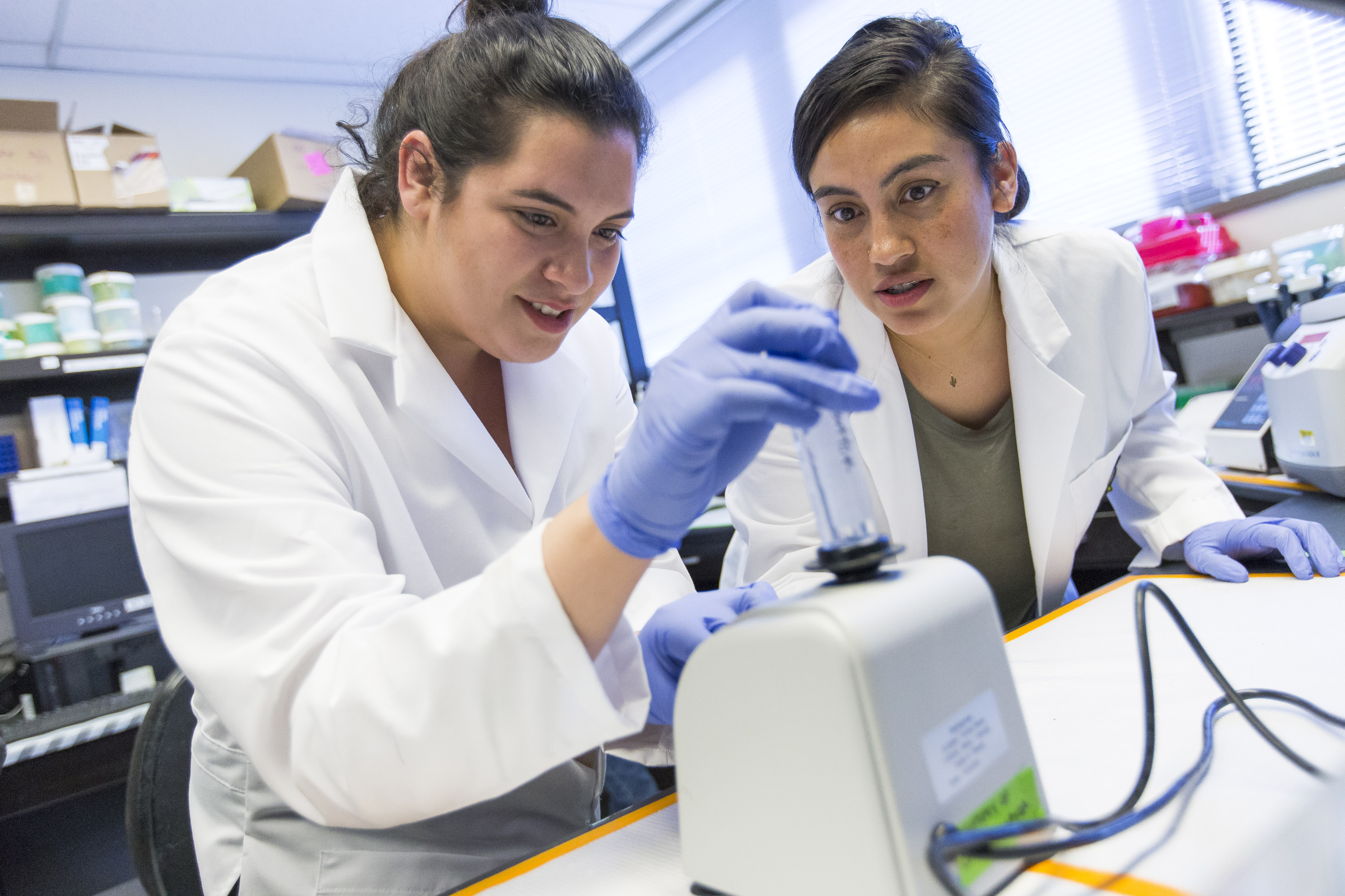 two female students working with instruments in a lab